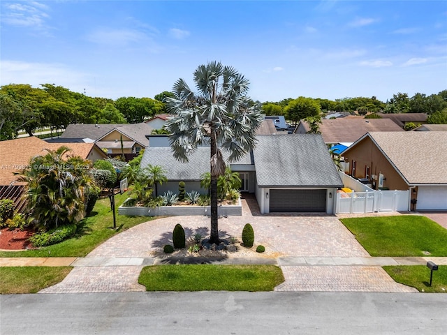 2421 NW 102nd Way, Pembroke Pines, FL 33026 - view of front of home with a garage, driveway, a residential view, and stucco siding