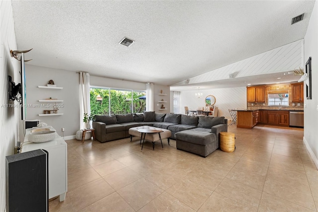 2421 NW 102nd Way, Pembroke Pines, FL 33026 - living area with healthy amount of natural light, a textured ceiling, and light tile patterned flooring