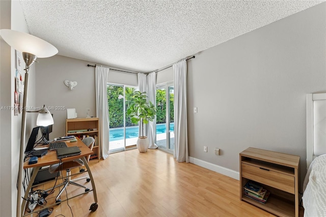 2421 NW 102nd Way, Pembroke Pines, FL 33026 - office area featuring a textured ceiling, light wood-style flooring, and baseboards