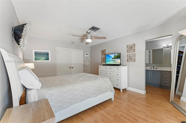 2421 NW 102nd Way, Pembroke Pines, FL 33026 - bedroom featuring light wood finished floors, a closet, a textured ceiling, a sink, and ceiling fan