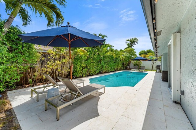 2421 NW 102nd Way, Pembroke Pines, FL 33026 - view of swimming pool featuring a fenced backyard and a patio