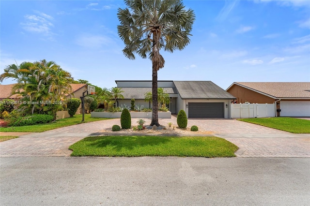 2421 NW 102nd Way, Pembroke Pines, FL 33026 - mid-century inspired home with decorative driveway, a garage, and stucco siding