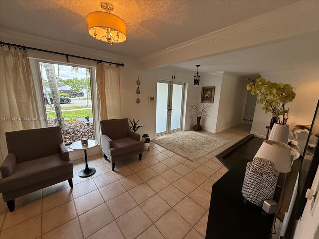 9720 SW 104th Ct, Miami, FL 33176 - living room featuring light tile patterned floors, crown molding, a textured ceiling, french doors, and baseboards