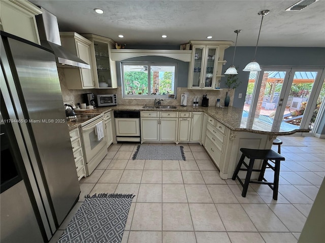 9720 SW 104th Ct, Miami, FL 33176 - kitchen featuring paneled dishwasher, white electric range oven, a sink, a peninsula, and tasteful backsplash