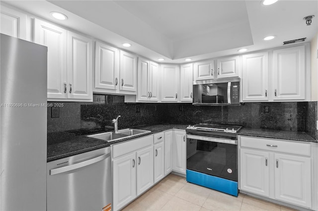 9511 Collins Ave Unit 806, Surfside, FL 33154 - kitchen with stainless steel appliances, recessed lighting, a sink, light tile patterned floors, and white cabinets