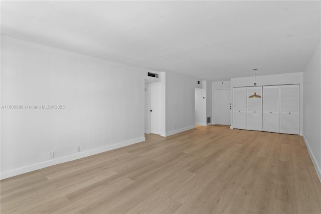9511 Collins Ave Unit 806, Surfside, FL 33154 - unfurnished living room with light wood-type flooring and baseboards
