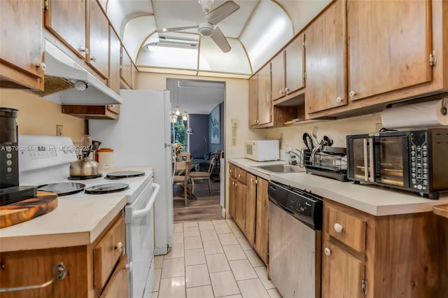 kitchen with white appliances, under cabinet range hood, ceiling fan, a sink, and light countertops