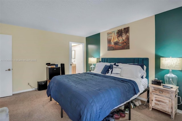 carpeted bedroom with baseboards and ensuite bathroom