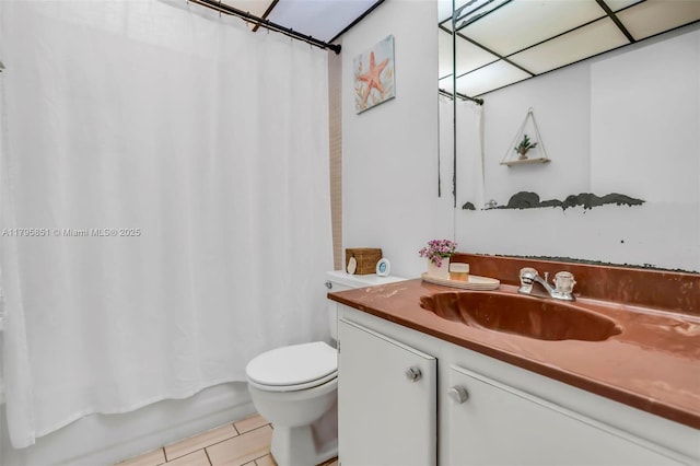 bathroom with tile patterned floors, toilet, shower / bathtub combination with curtain, and vanity