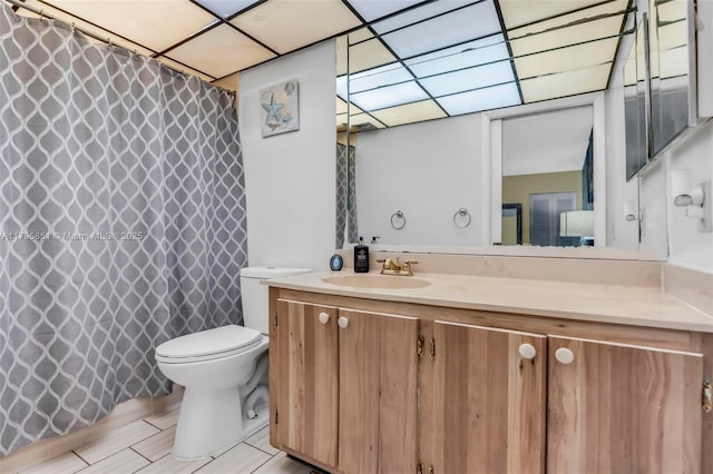 bathroom featuring vanity, toilet, and a shower with shower curtain