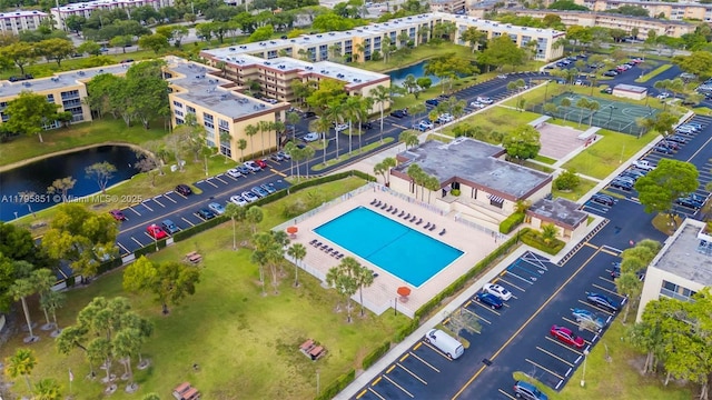 aerial view of a large body of water, a pool, and apartment complex / building