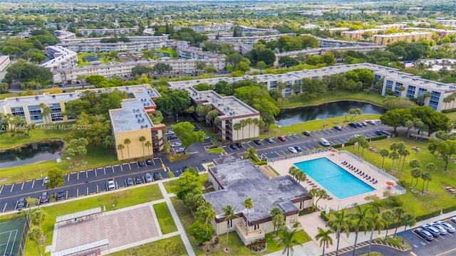 drone / aerial view of a large body of water and a pool area