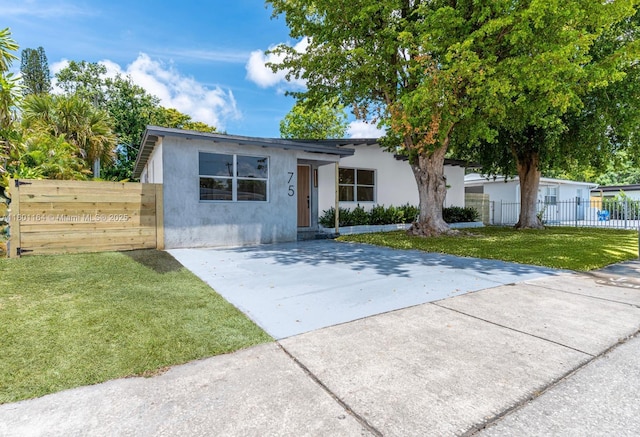 75 NW 125th St, North Miami, FL 33168 - view of front of house with stucco siding and concrete driveway