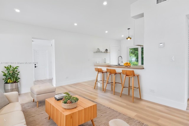 75 NW 125th St, North Miami, FL 33168 - living area featuring recessed lighting, light wood-style floors, and baseboards