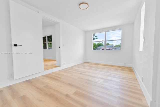 75 NW 125th St, North Miami, FL 33168 - empty room featuring plenty of natural light, light wood-type flooring, and baseboards