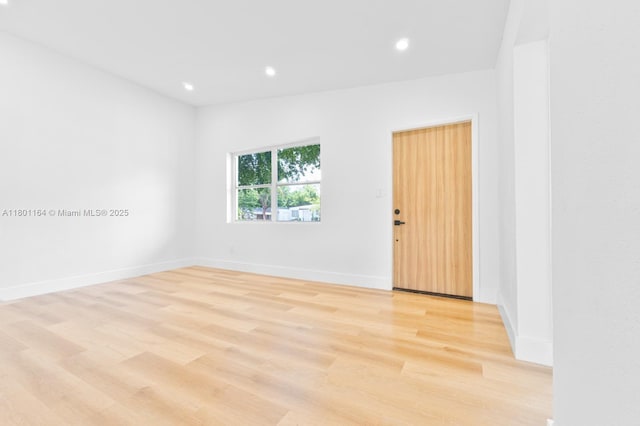 75 NW 125th St, North Miami, FL 33168 - empty room with light wood finished floors, recessed lighting, and baseboards