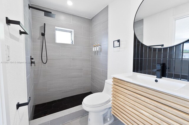 75 NW 125th St, North Miami, FL 33168 - bathroom featuring toilet, tiled shower, vanity, and tile patterned floors