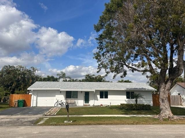 12821 SW 10th Ct, Davie, FL 33325 - single story home with a garage, driveway, and stucco siding