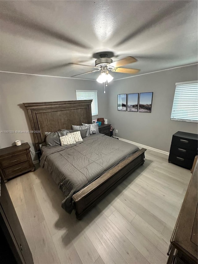 12821 SW 10th Ct, Davie, FL 33325 - bedroom with light wood-style floors, baseboards, a ceiling fan, and a textured ceiling