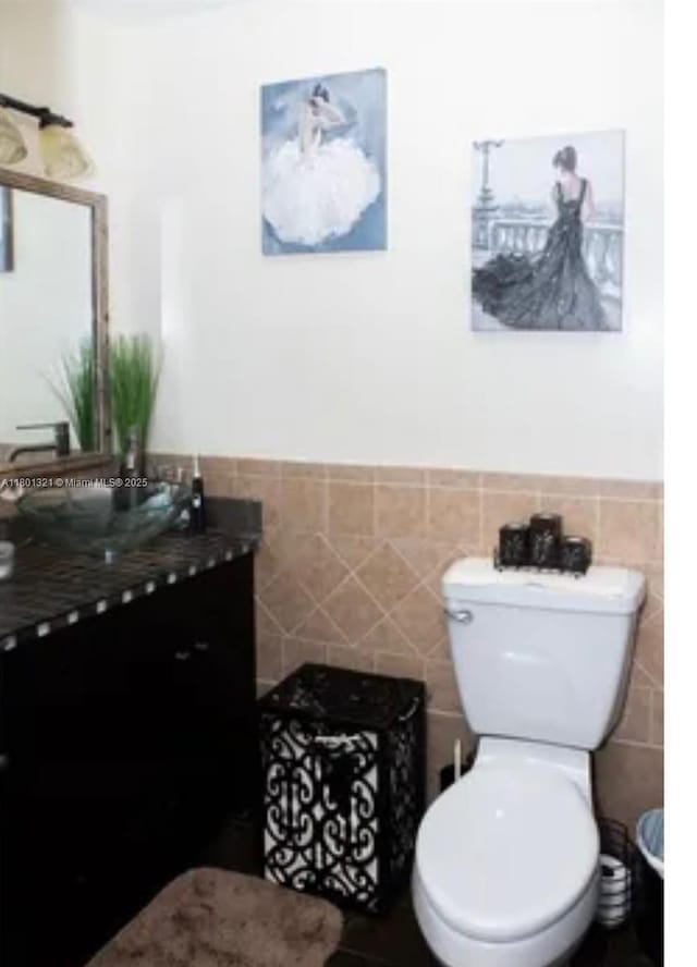 12821 SW 10th Ct, Davie, FL 33325 - bathroom with tile walls, vanity, toilet, and wainscoting