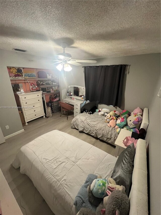 12821 SW 10th Ct, Davie, FL 33325 - bedroom with a textured ceiling, wood finished floors, and ceiling fan