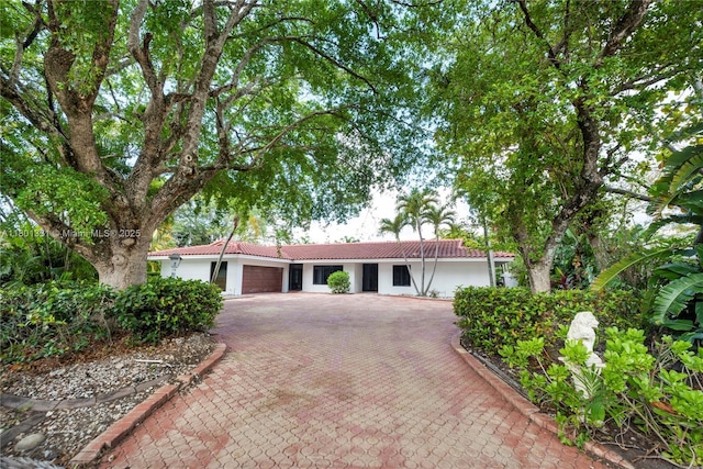 2800 Palmer Dr, Hollywood, FL 33021 - ranch-style home with a tile roof, an attached garage, stucco siding, and decorative driveway