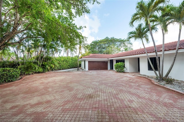 2800 Palmer Dr, Hollywood, FL 33021 - view of front of property with stucco siding, an attached garage, a tiled roof, and decorative driveway