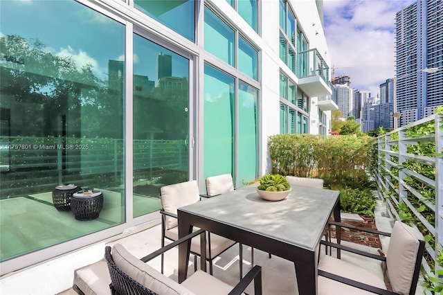 1600 SW 1st Ave Unit Th-07, Miami, FL 33129 - balcony featuring a city view and outdoor dining area