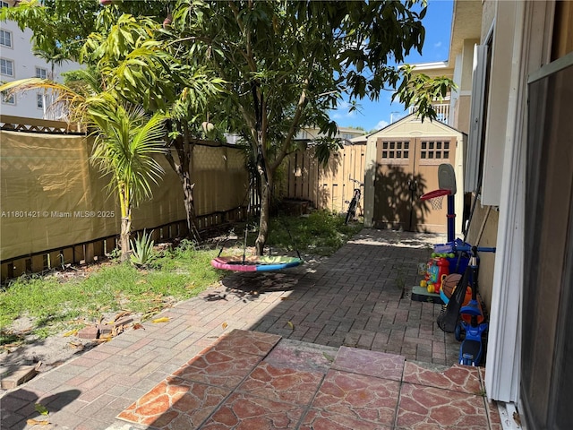 4360 NW 79th Ave Unit 1F, Doral, FL 33166 - fenced backyard with a storage unit and a patio