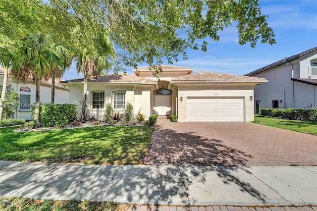 3360 SW 195th Ter, Miramar, FL 33029 - mediterranean / spanish home with an attached garage, stucco siding, decorative driveway, a tiled roof, and a front yard