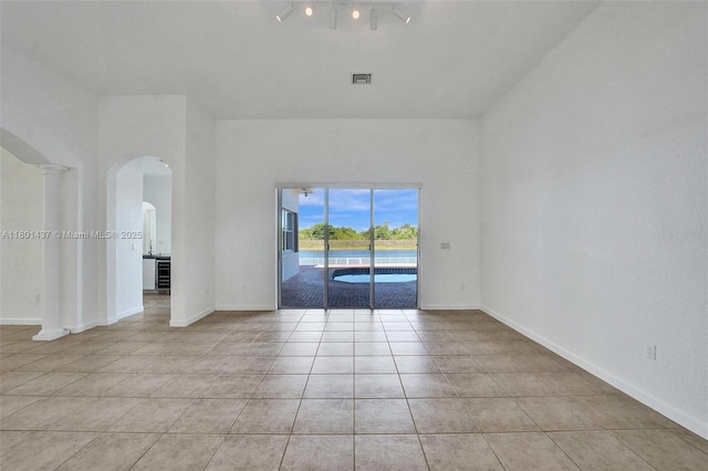 3360 SW 195th Ter, Miramar, FL 33029 - empty room with arched walkways, light tile patterned floors, and baseboards