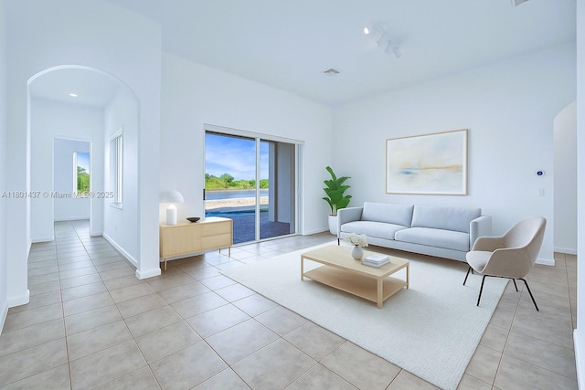 3360 SW 195th Ter, Miramar, FL 33029 - living room with arched walkways, light tile patterned flooring, and healthy amount of natural light