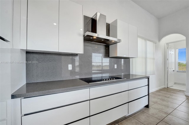 3360 SW 195th Ter, Miramar, FL 33029 - kitchen featuring wall chimney exhaust hood, arched walkways, white cabinetry, and decorative backsplash