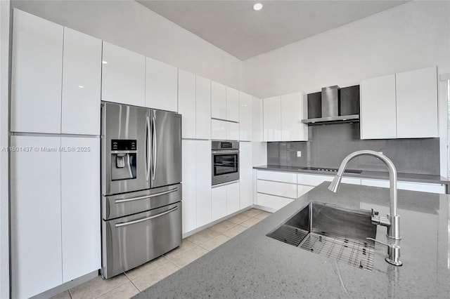 3360 SW 195th Ter, Miramar, FL 33029 - kitchen with stainless steel appliances, wall chimney exhaust hood, a sink, light stone counters, and decorative backsplash