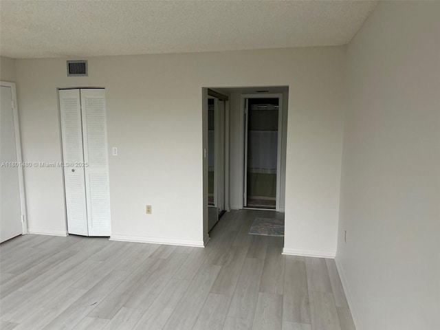 1000 Colony Point Cir Unit 302, Pembroke Pines, FL 33026 - unfurnished bedroom with wood finished floors, a closet, baseboards, and a textured ceiling