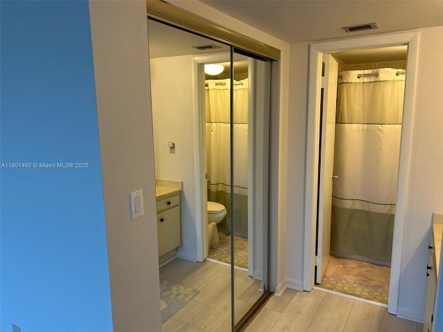 1000 Colony Point Cir Unit 302, Pembroke Pines, FL 33026 - full bath with wood finished floors, vanity, toilet, and a shower with curtain