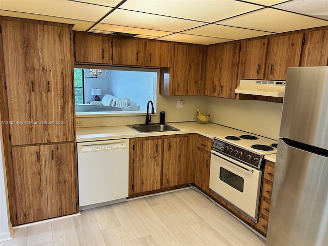 1000 Colony Point Cir Unit 302, Pembroke Pines, FL 33026 - kitchen with white appliances, under cabinet range hood, a sink, light countertops, and brown cabinetry