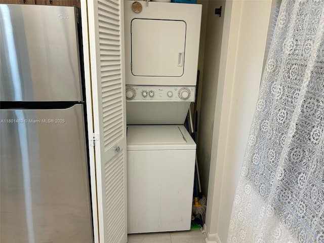 1000 Colony Point Cir Unit 302, Pembroke Pines, FL 33026 - washroom with stacked washer / drying machine, baseboards, and light tile patterned flooring