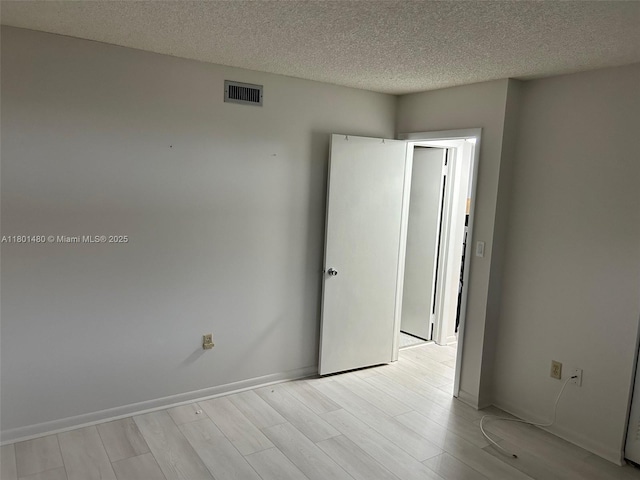 1000 Colony Point Cir Unit 302, Pembroke Pines, FL 33026 - unfurnished room with light wood-style floors and a textured ceiling