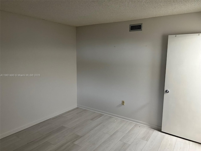 1000 Colony Point Cir Unit 302, Pembroke Pines, FL 33026 - empty room featuring light wood finished floors, a textured ceiling, and baseboards