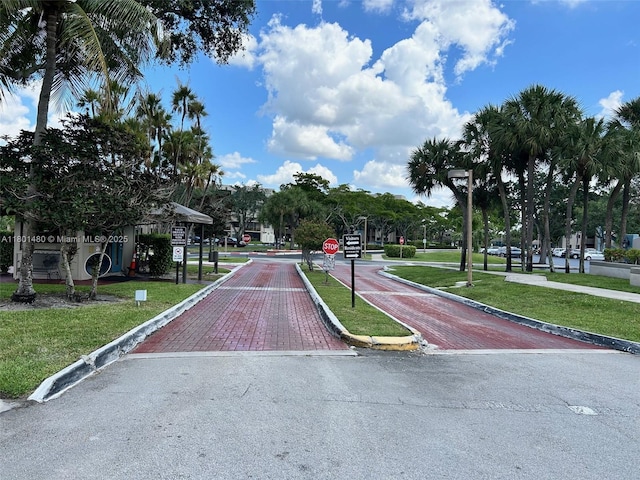 1000 Colony Point Cir Unit 302, Pembroke Pines, FL 33026 - view of asphalt road featuring traffic signs and curbs