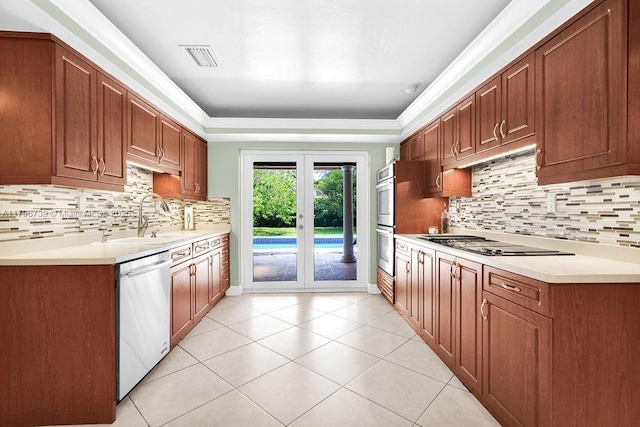 6551 SW 126th St, Pinecrest, FL 33156 - kitchen with stainless steel appliances, a sink, decorative backsplash, and light countertops