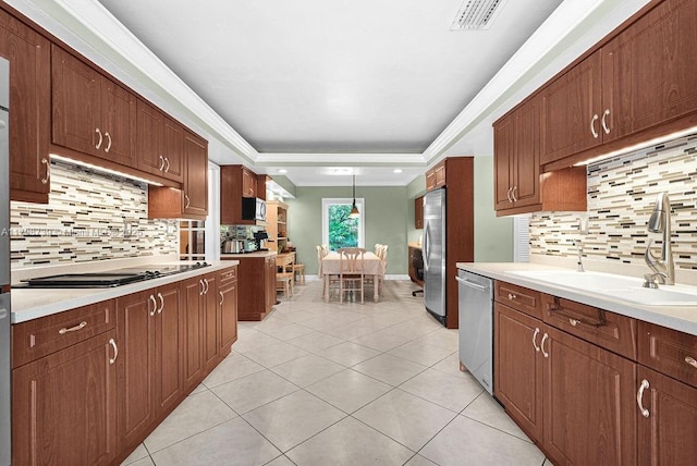6551 SW 126th St, Pinecrest, FL 33156 - kitchen featuring stainless steel appliances, tasteful backsplash, light countertops, a sink, and crown molding