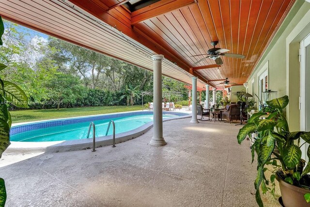 6551 SW 126th St, Pinecrest, FL 33156 - swimming pool with ceiling fan, a patio area, and a yard