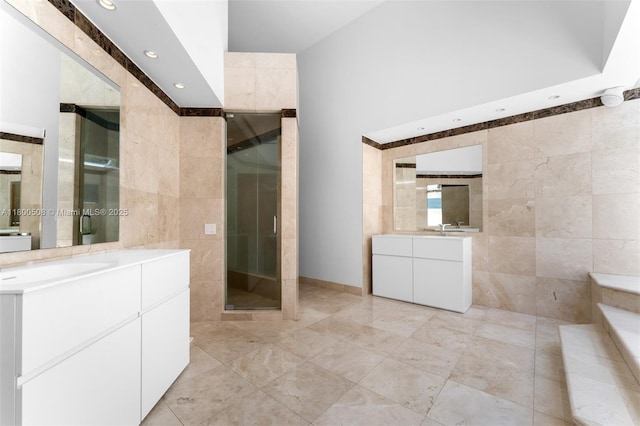 9500 SW 60th Ct, Pinecrest, FL 33156 - bathroom featuring tile walls, recessed lighting, a stall shower, two vanities, and tile patterned floors