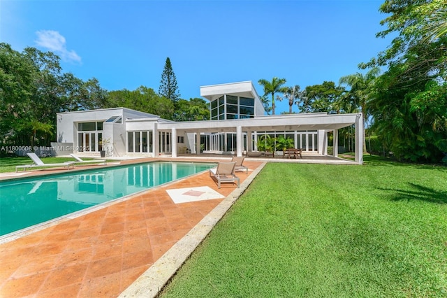 9500 SW 60th Ct, Pinecrest, FL 33156 - rear view of house with a patio area, a lawn, and an outdoor pool