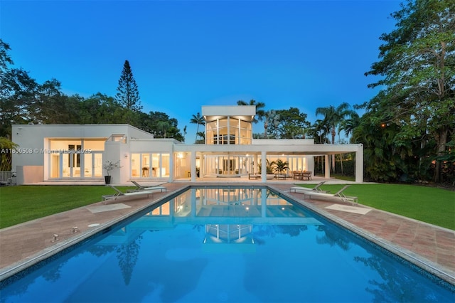 9500 SW 60th Ct, Pinecrest, FL 33156 - rear view of house with a patio area, a yard, an outdoor pool, and french doors