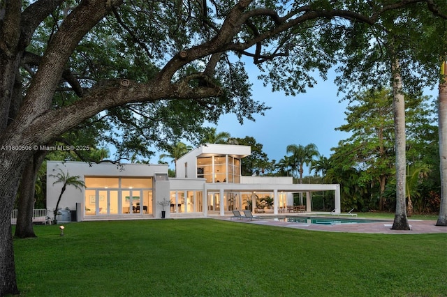 9500 SW 60th Ct, Pinecrest, FL 33156 - rear view of property with a yard, stucco siding, an outdoor pool, and a patio