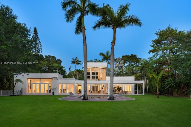 9500 SW 60th Ct, Pinecrest, FL 33156 - rear view of house featuring a yard, a patio area, and stucco siding
