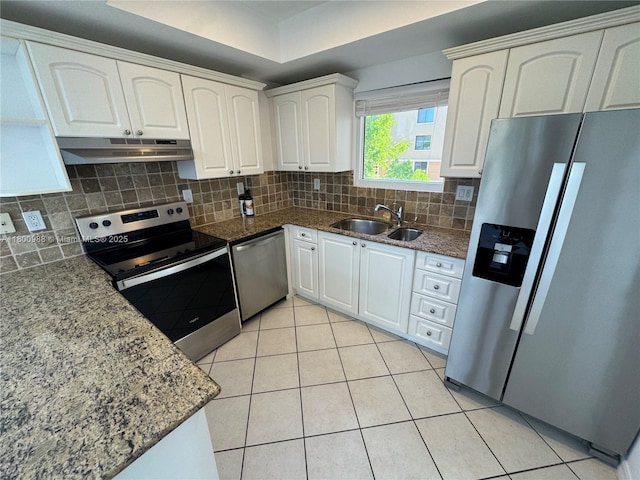 3500 Coral Way Unit 501, Miami, FL 33145 - kitchen featuring appliances with stainless steel finishes, a sink, under cabinet range hood, white cabinetry, and light tile patterned floors